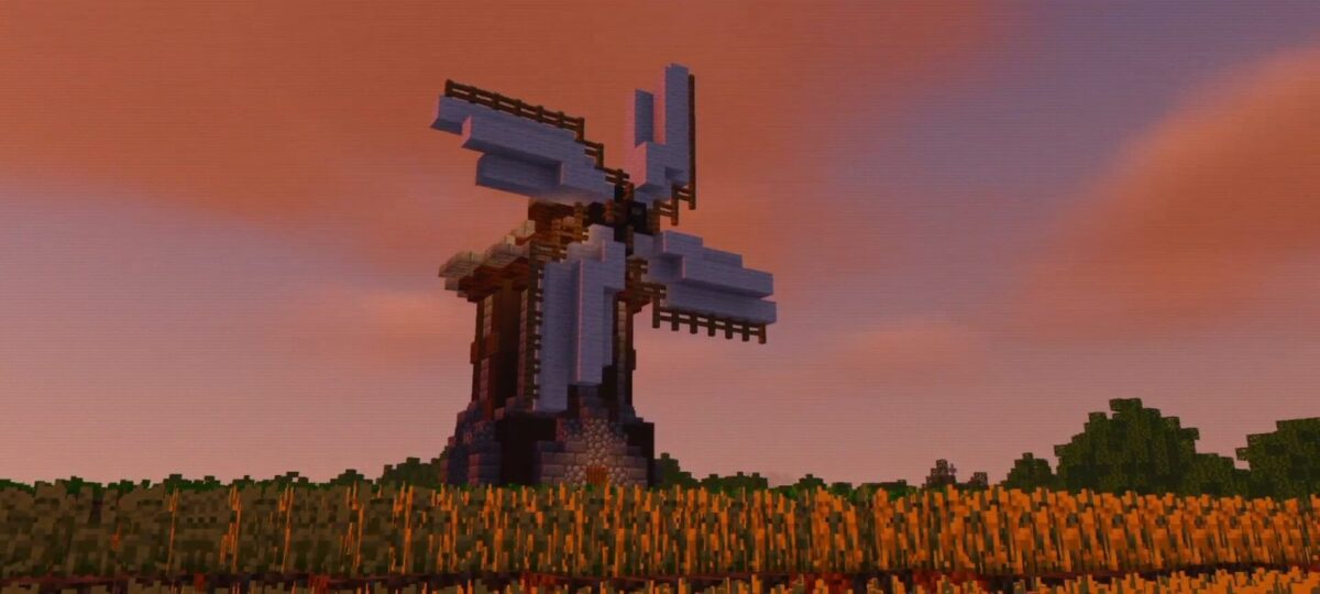 moulin dans un champ au coucher de soleil dans Minecraft avec Bicubic Shaders BE