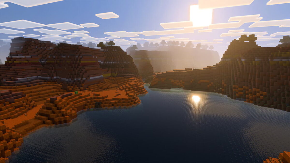 Biome des badlands dans Minecraft, éclairé par le soleil couchant à travers le Vibrant Shader, révélant reliefs et couleurs chaudes.