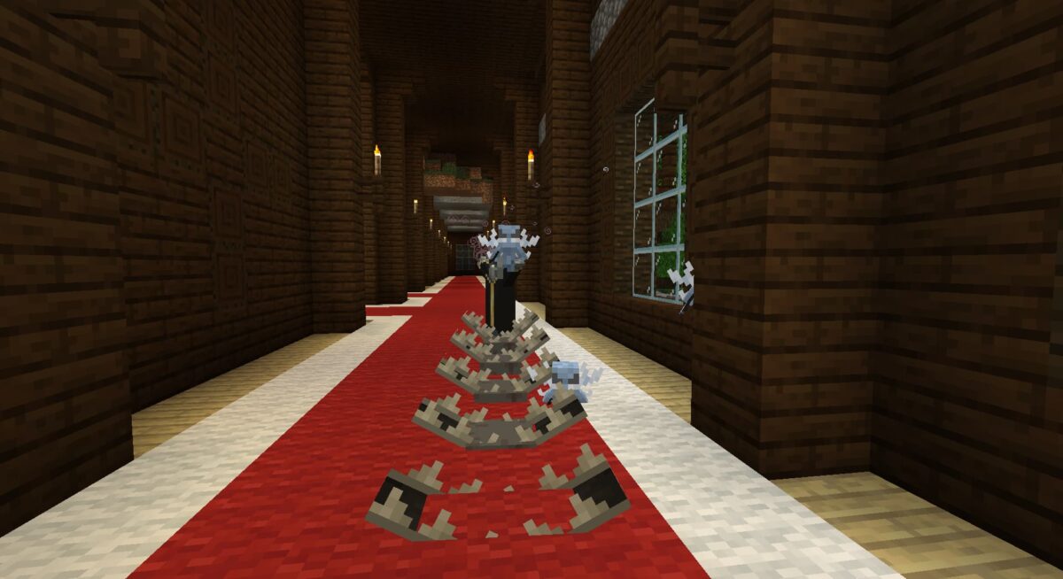 Un évocateur de minecraft lance une attaque magique pendant que ses vexes combattent aux alentours