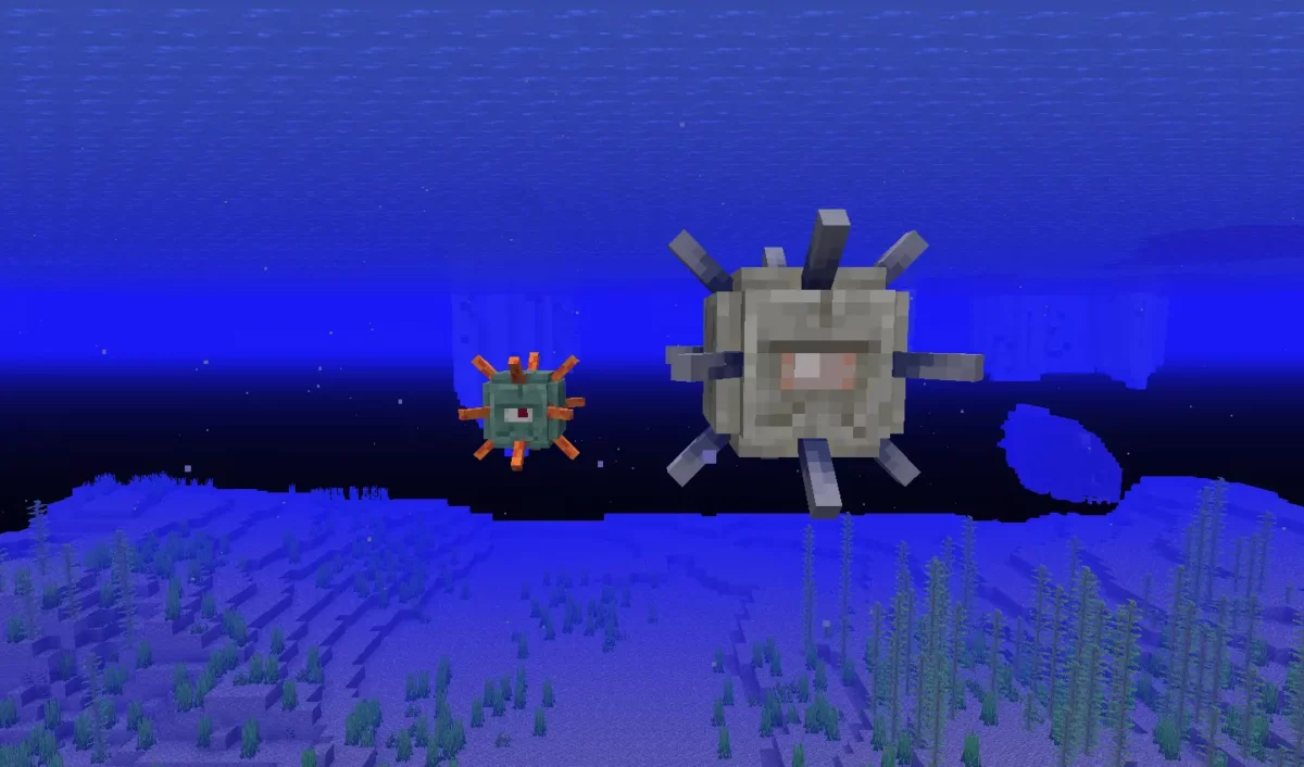 Un gardien et un grand gardien côte à côte, flottant dans l’océan de Minecraft.