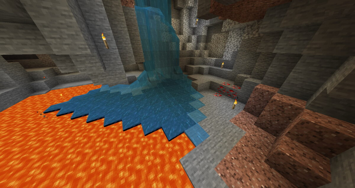 Cascade d’eau transformant la lave en obsidienne dans une caverne Minecraft.