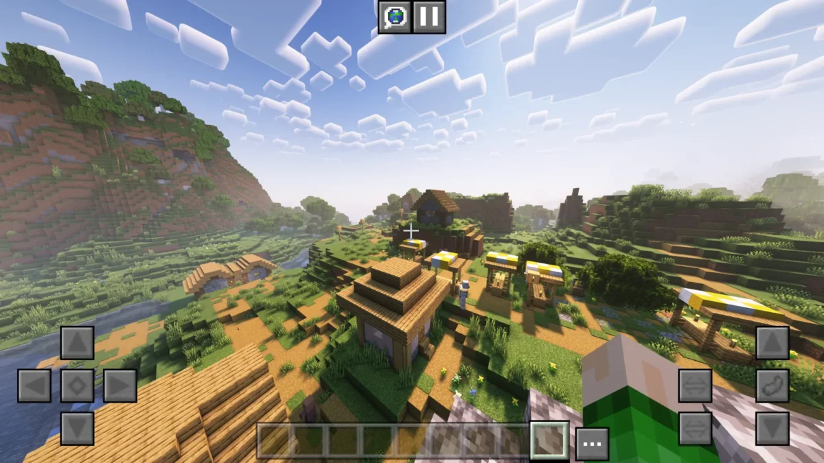 Affichage des commandes tactiles dans Minecraft grâce au mod MidnightControls, avec boutons de déplacement visibles à l’écran sur une vue en plein jour.