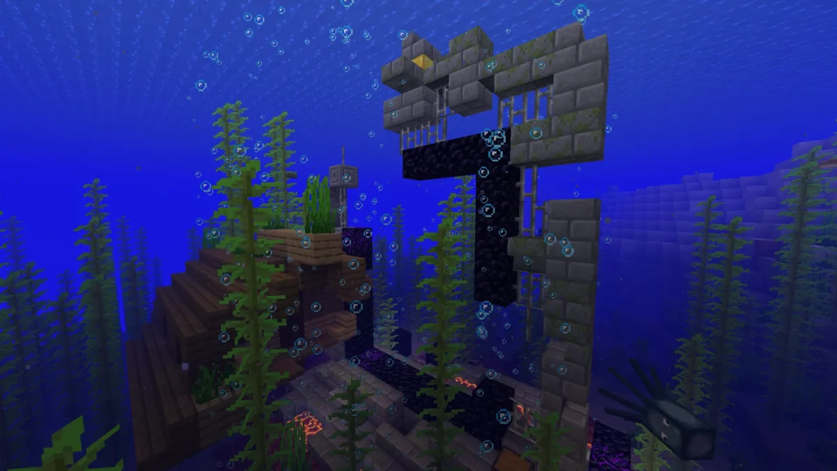 Portail du Nether en ruine submergé dans Minecraft, généré au fond de l’océan près d’une épave, avec colonnes de bulles