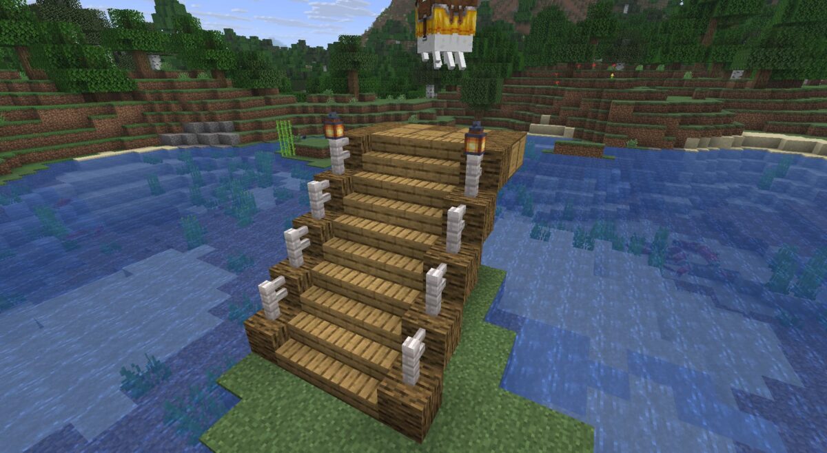 Escalier terminé avec barrières et lanternes pour une station de ghasts joyeux dans Minecraft.