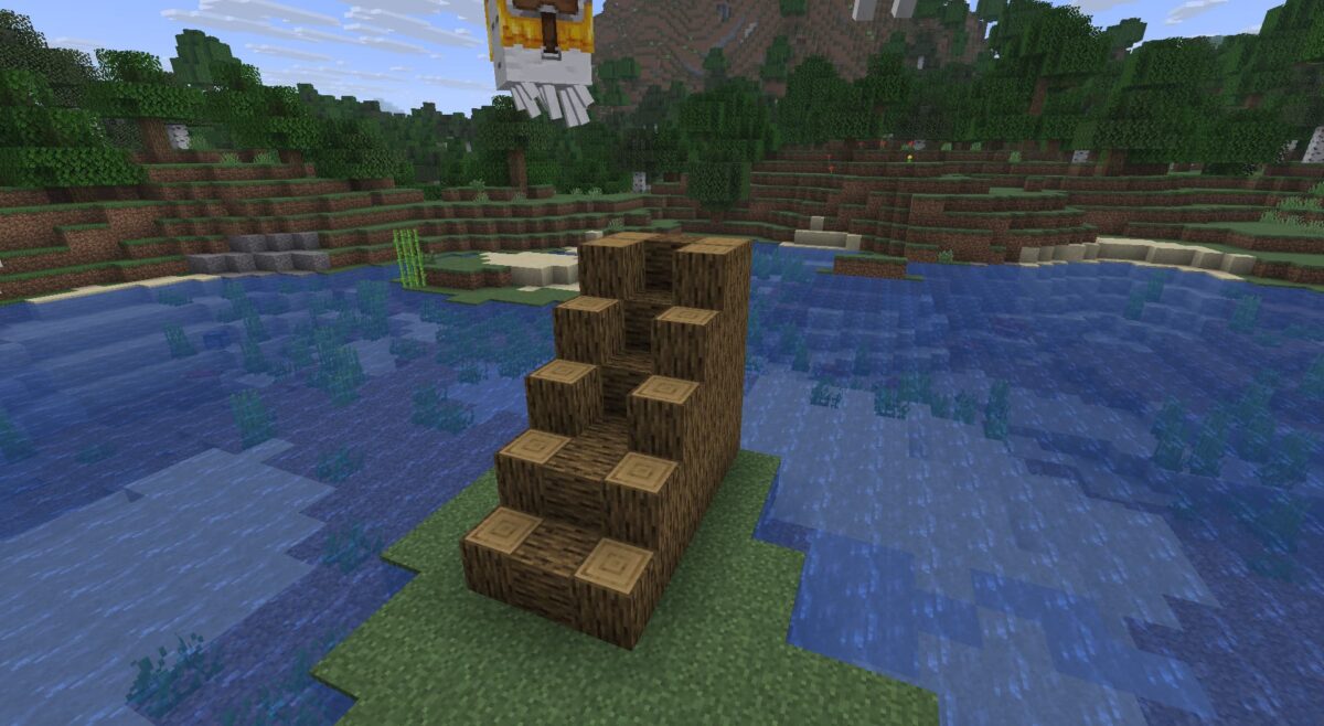 Début de la construction d’un escalier en bûches dans Minecraft pour une station de ghasts joyeux.