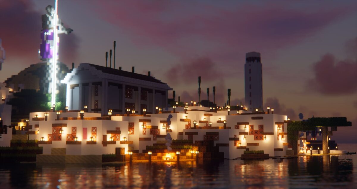 Quartier côtier de la Greek City map Minecraft avec temple classique, maisons blanches en terrasse et grande statue éclairée sur la colline.