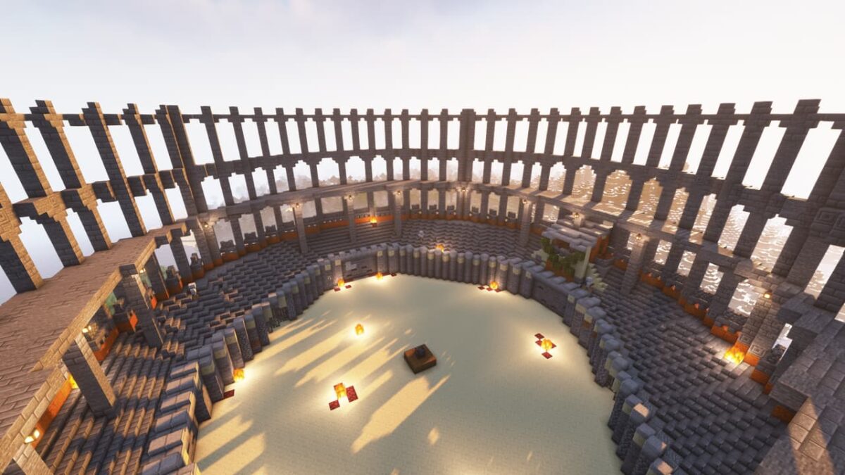 Arène circulaire en pierre éclairée par des torches, structure de type colisée dans le mod When Dungeons Arise pour Minecraft.