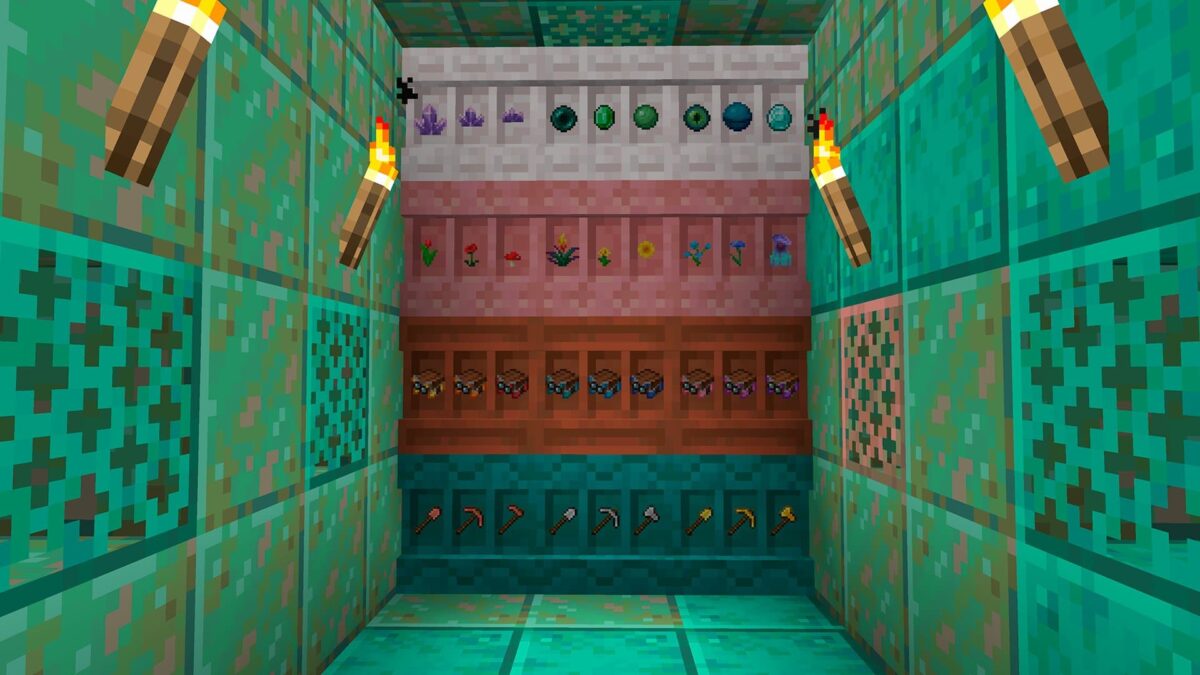 Mur d’exposition composé de plusieurs blocs d’étagères dans Minecraft, présentant des outils, des fleurs, des minerais, des livres enchantés et des objets rares.