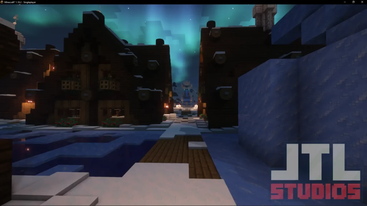 Allée et habitations d’un village enneigé de nuit retravaillé par le mod Minecraft Better Villages avec ambiance polaire