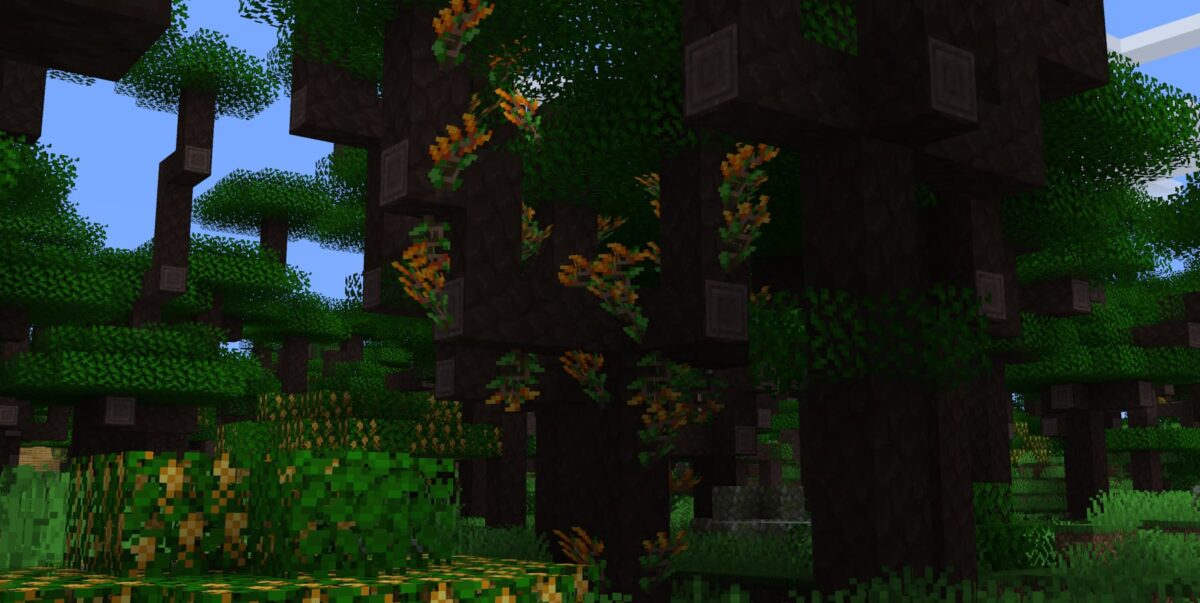 mod Minecraft Atmospheric illustrant un arbre couvert de monkey brush aux fleurs colorées