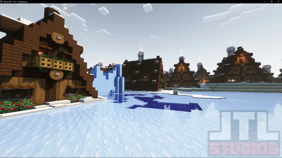 Maisons d’un village enneigé retravaillées par le mod Minecraft Better Villages avec implantation autour d’une zone gelée