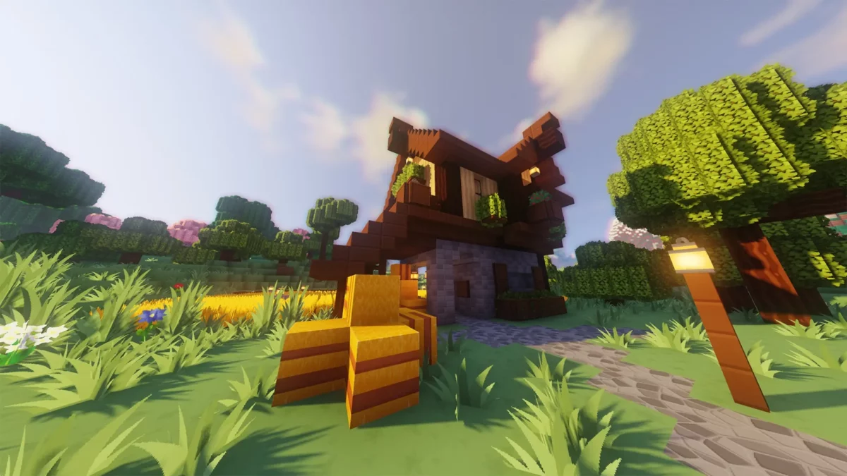 pack de texture Minecraft SimonKraft affichant une maison champêtre avec bottes de foin et lumière douce en fin de journée