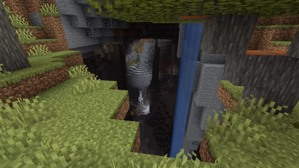 shader Minecraft I Like Vanilla vue plongeante sur une grotte profonde traversée par une cascade