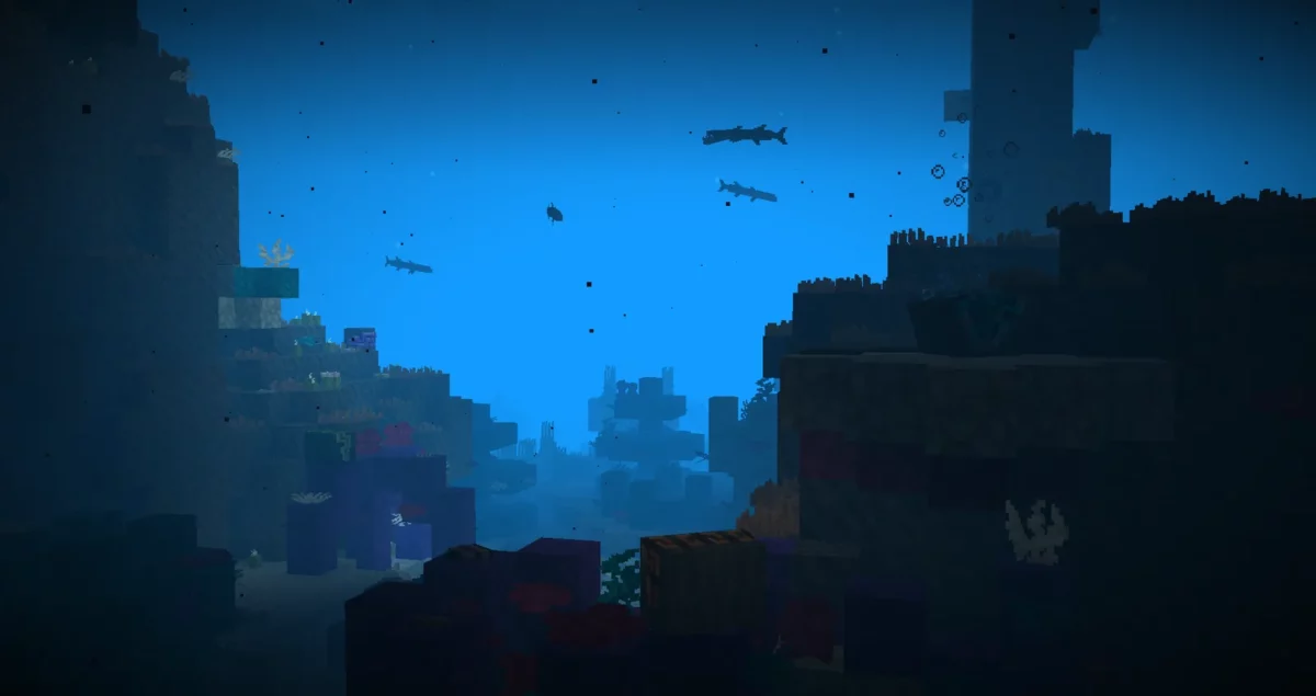 mod Minecraft Spawn récif corallien profond avec silhouettes de poissons et palourdes géantes au sol