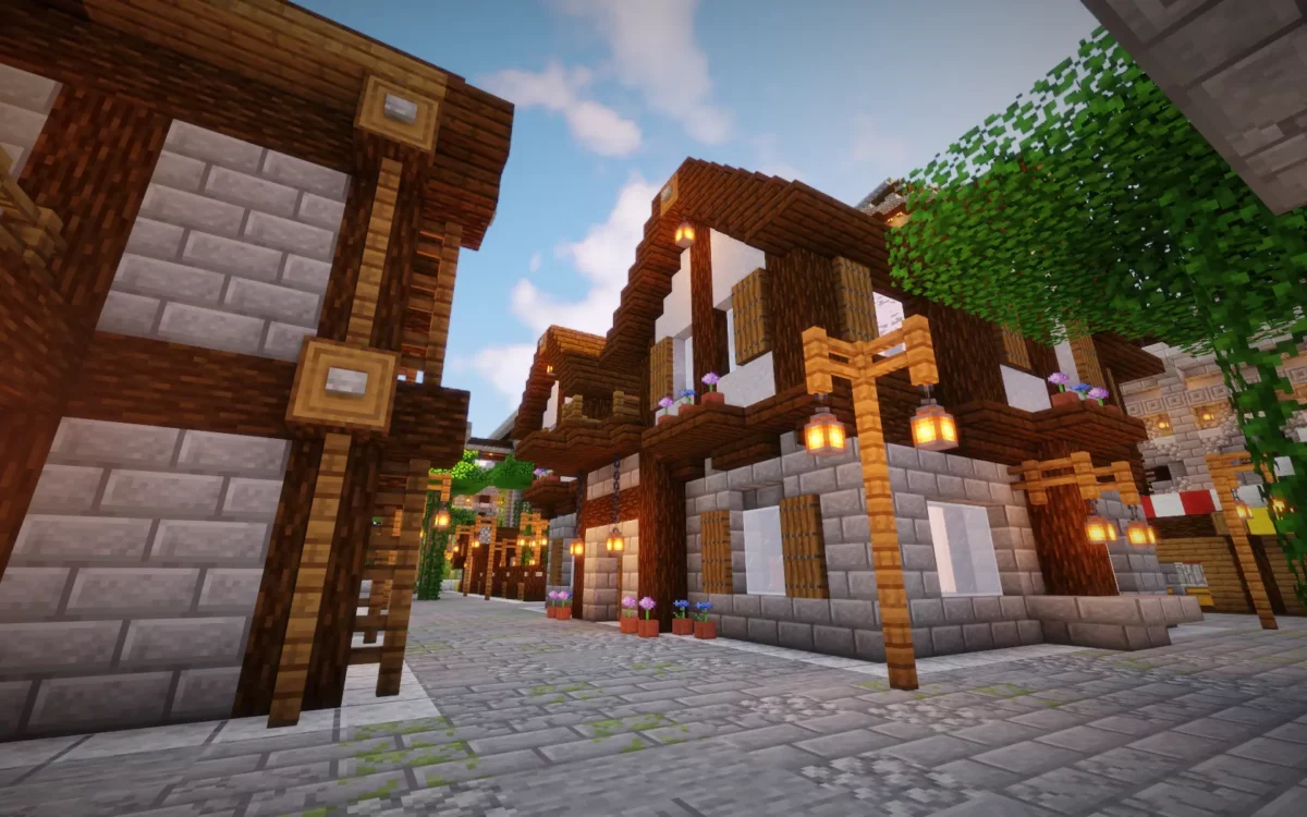 mod Minecraft The Lost Castle rue intérieure bordée de maisons à colombages et de lampadaires en bois