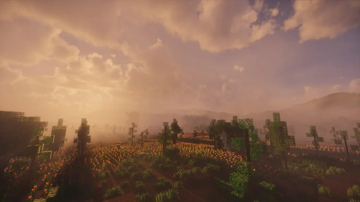 shader Minecraft Spring Shaders coucher de soleil orangé sur des collines boisées avec un ciel en dégradé