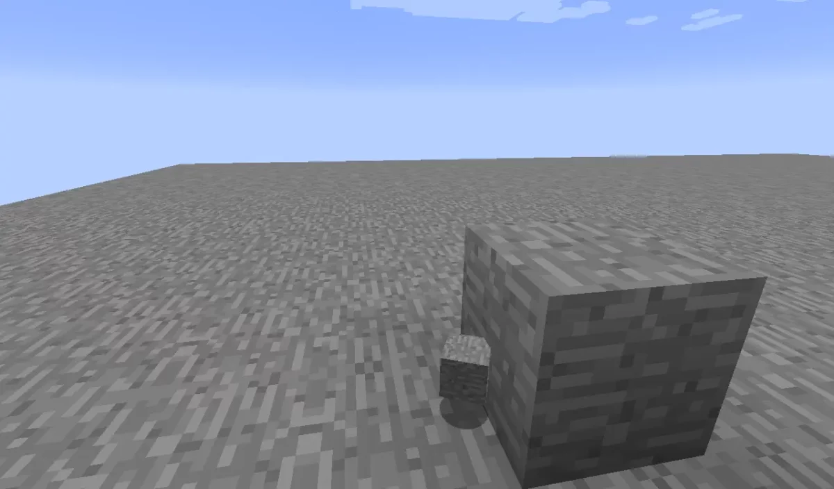 bug MC-4 de Minecraft un petit objet de pierre posé au sol au pied d'un bloc de pierre