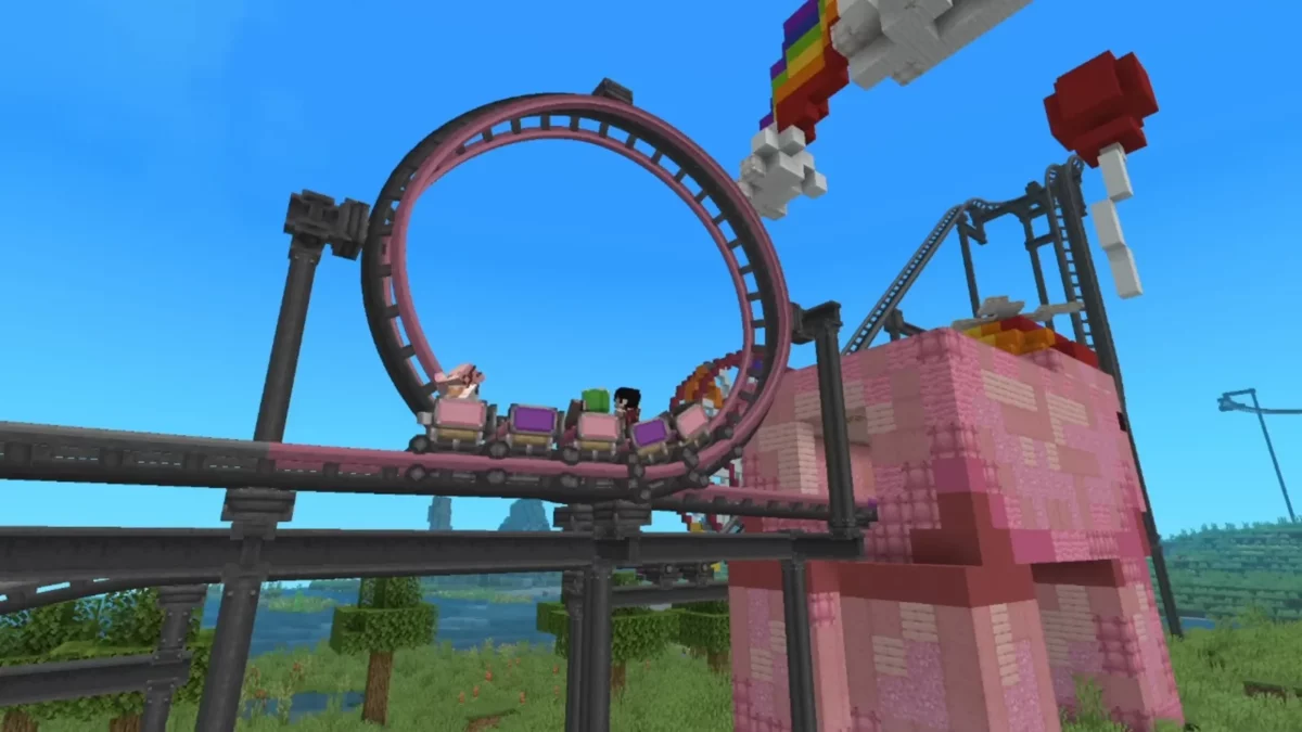 Wagonnets de Create Coasters Simulated engagés dans un looping rose au-dessus d’un parc Minecraft