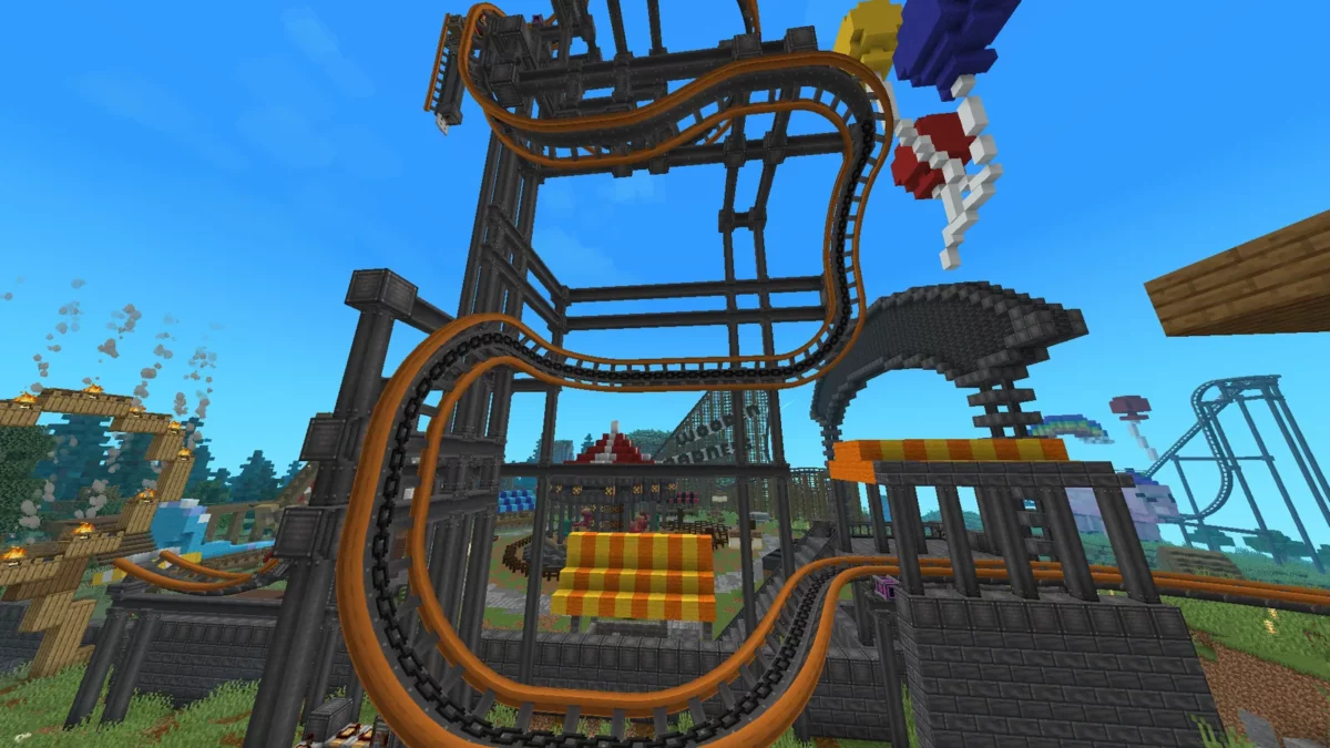 Rails colorés de Create Coasters Simulated formant des virages inclinés et des torsades dans Minecraft