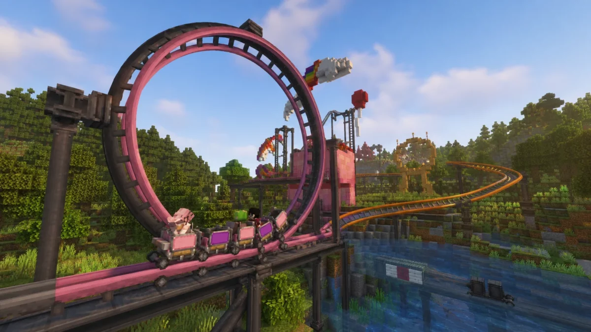 Train de wagonnets Create Coasters Simulated devant un grand looping rose dans Minecraft
