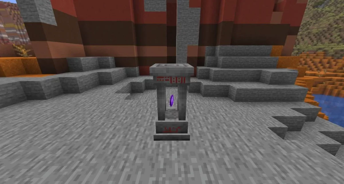 Sharestone redessinée par Fresh Waystones Texture au centre d’une zone rocheuse dans Minecraft