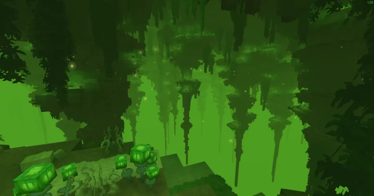 Caverne profonde baignée d'une lumière verte avec de longues stalactites dans Hytale