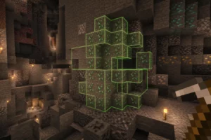 VeinMiner Hotkey est un mod qui déclenche le minage en chaîne avec une touche dédiée Filon de minerais entouré en vert avant son extraction avec VeinMiner Hotkey dans une vaste caverne Minecraft