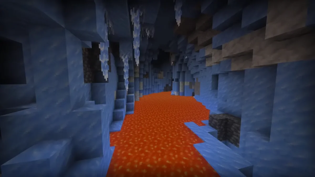 Une étendue de lave orange contraste avec les parois bleues d’une grotte de glace dans Minecraft