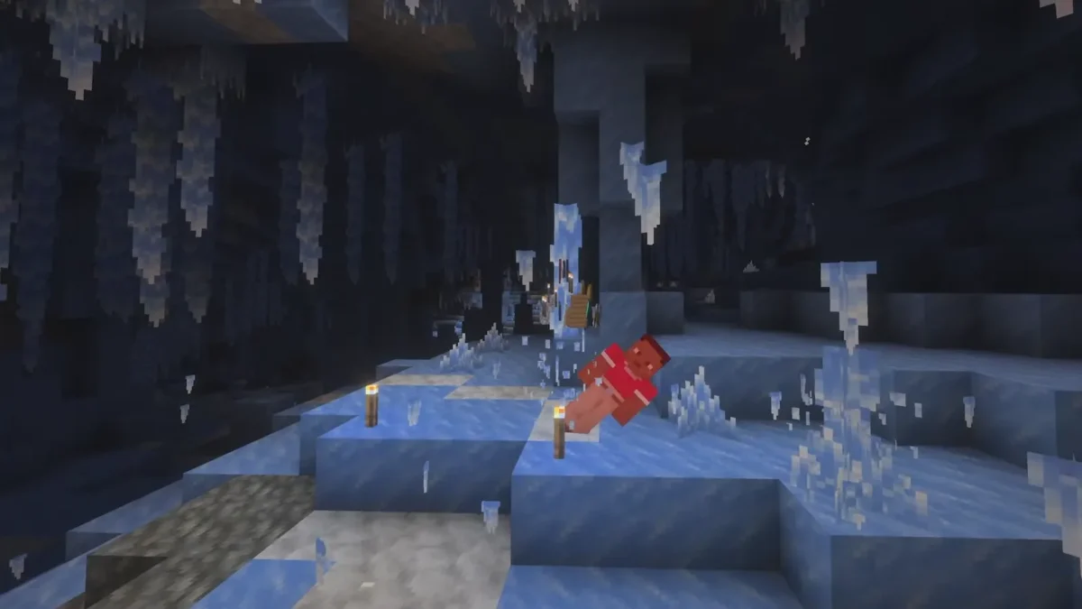 Des créatures se trouvent sous les stalactites dans une grotte glacée pendant la démonstration de Minecraft