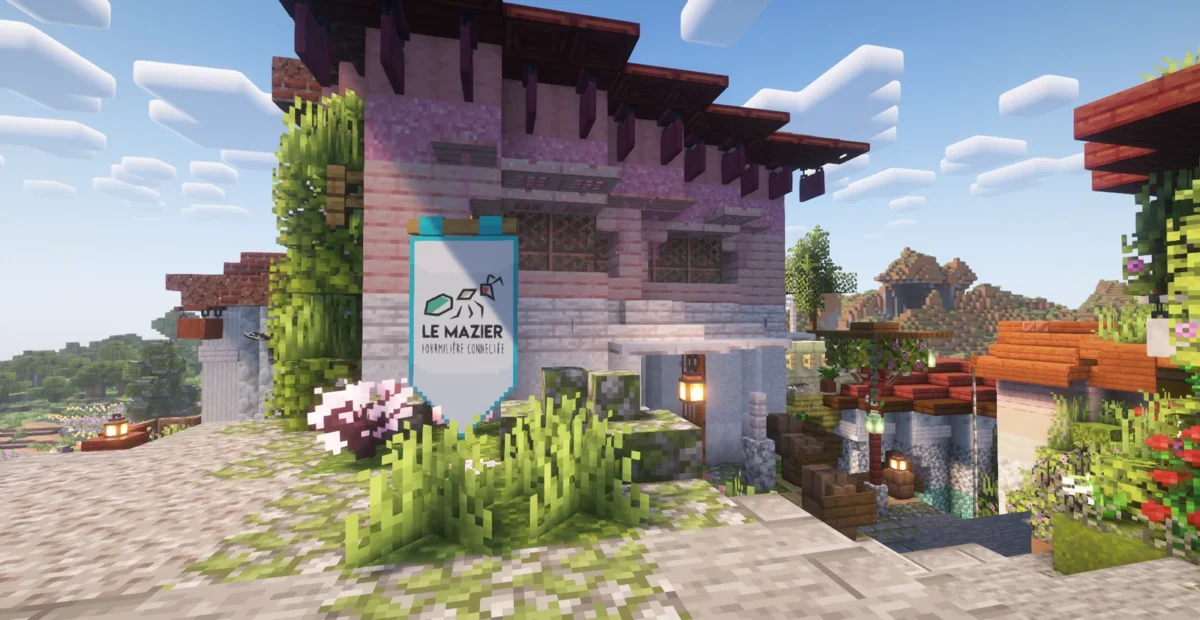 Bâtiment rose du Mazier entouré de fleurs, de végétation et de lanternes dans la Cité Solidaire