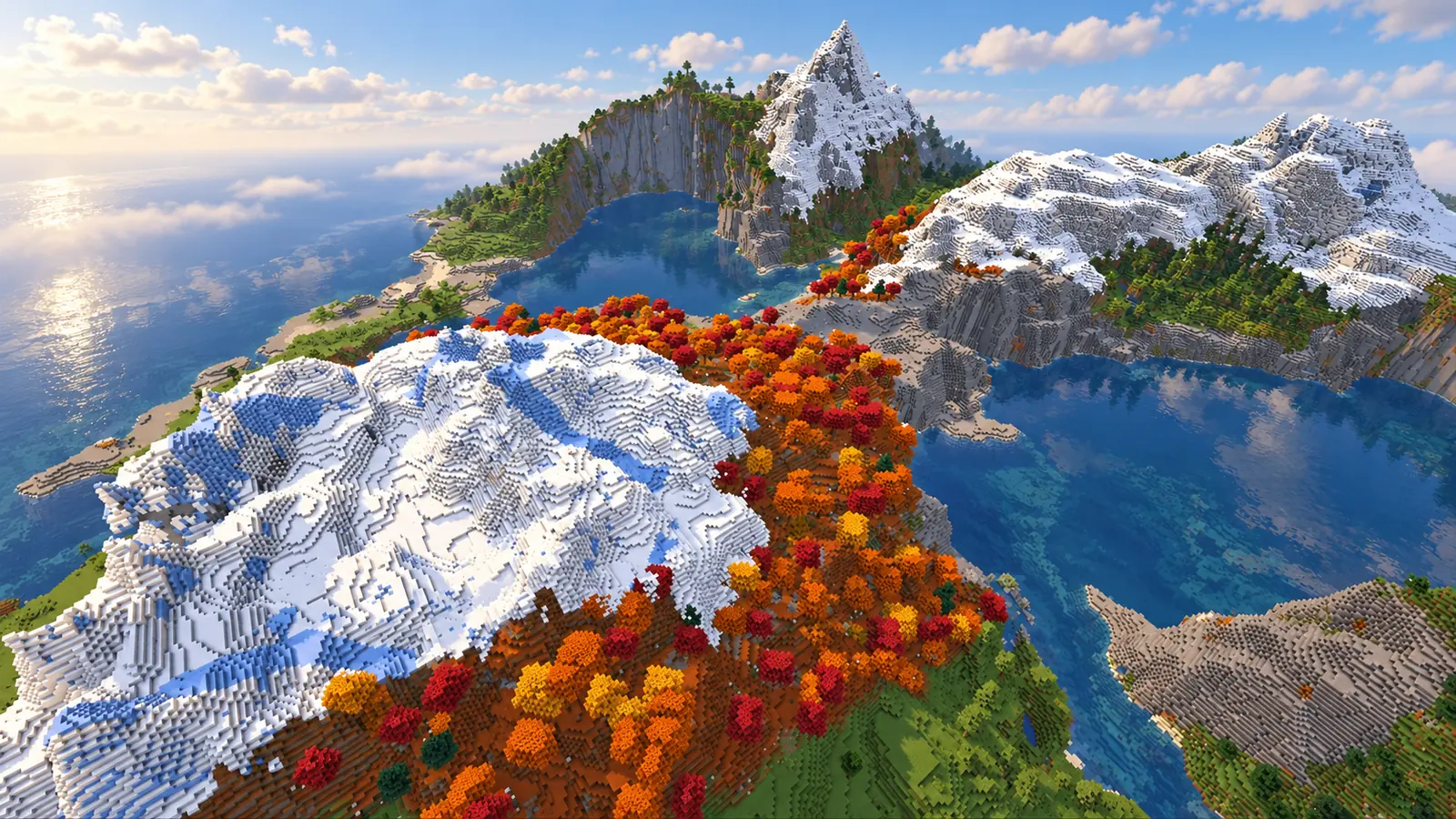Chaîne de montagnes enneigées bordée de forêt tachetée rouge et orange entre plusieurs lacs dans cette seed Minecraft