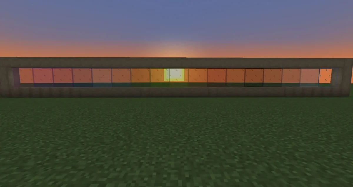 Rangée de vitres colorées Minecraft illustrant les textures connectées dans un mur de démonstration au crépuscule