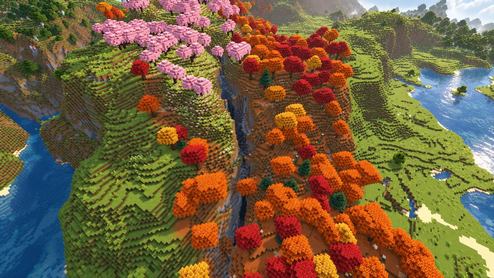 Profond ravin de pierre séparant des cerisiers roses et une forêt tachetée orange dans cette seed Minecraft